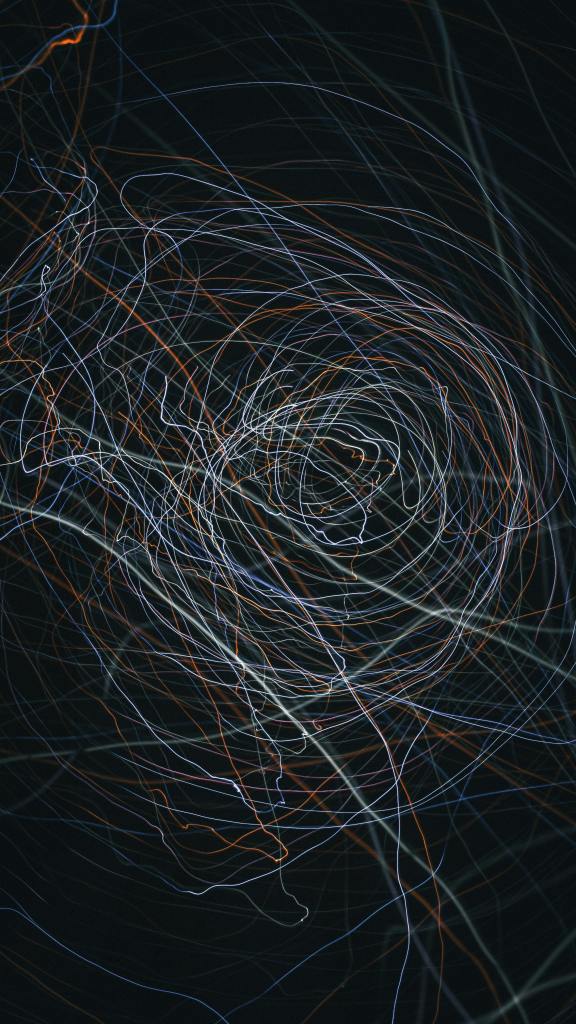Captivating abstract with swirling light trails in a dark setting, creating a dynamic visual effect.